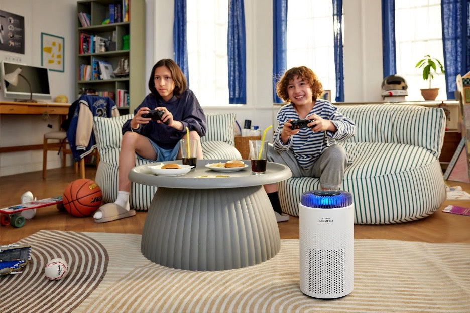 Kids playing video games with an air purifier in the room.