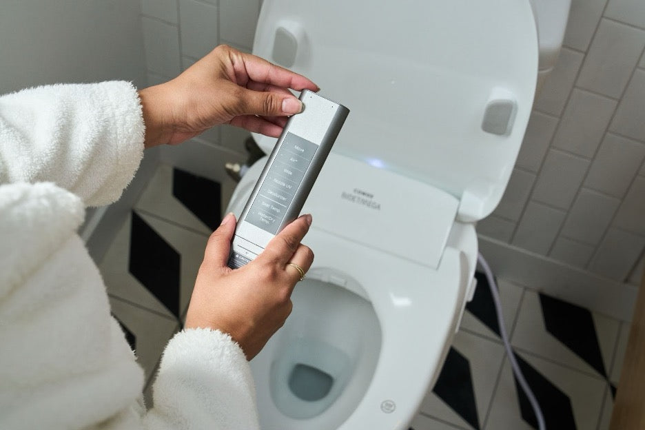A person using the Bidetmega 500S remote.