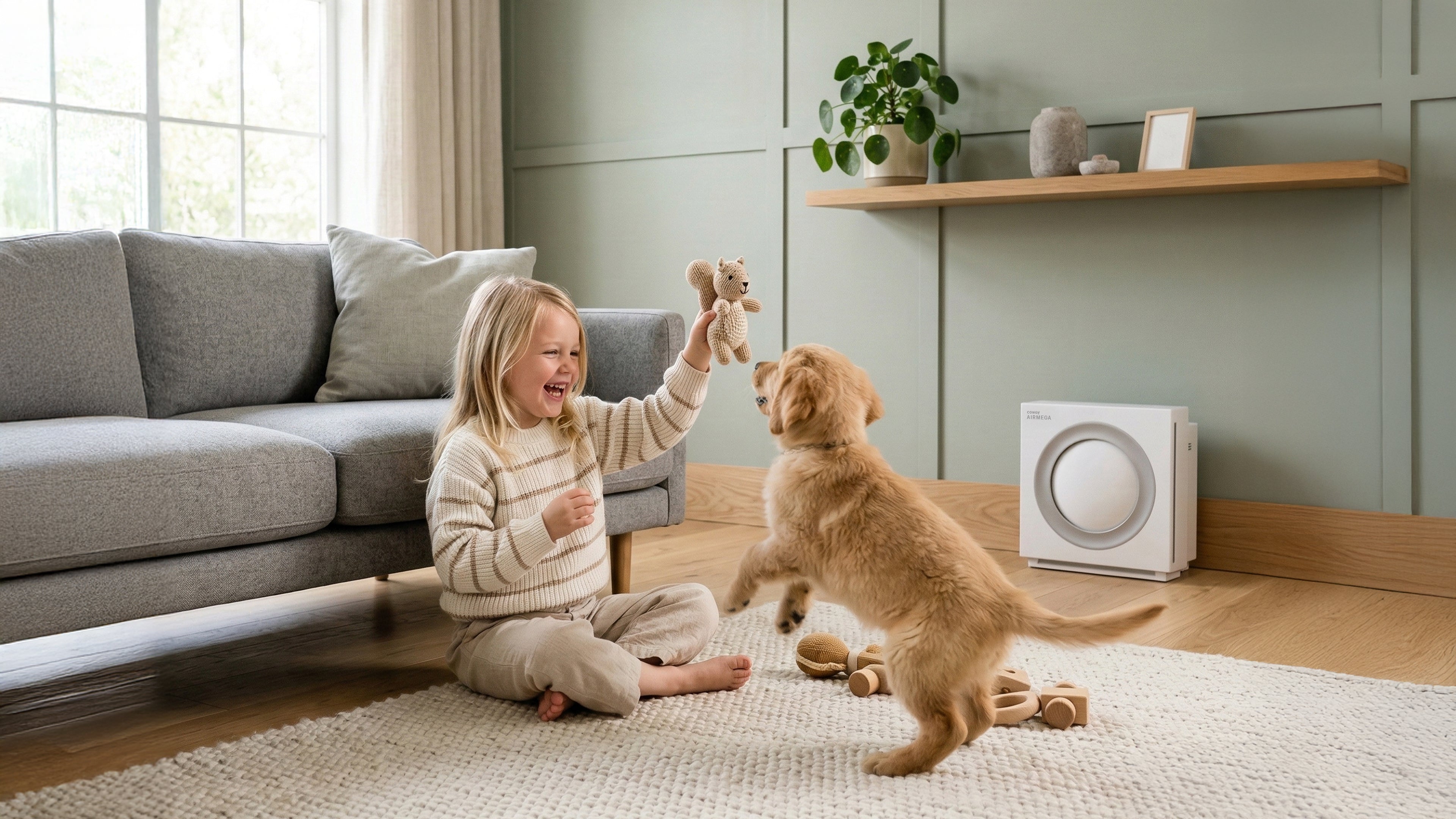 A child and her dog beside the&nbsp; Airmega Mighty2 air purifier.