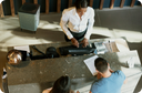 Couple checking into from desk with Airmega air purifier