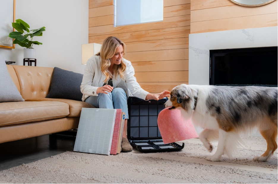 A woman and her dog with an air filter.